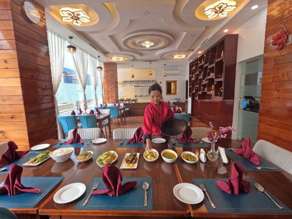 Dishes being served at a set table in the restaurant