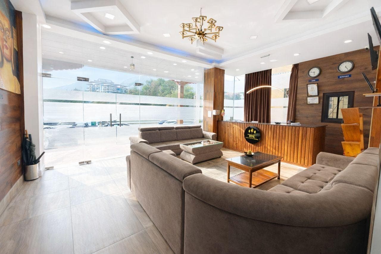 Reception lounge with grey sofas and the front desk